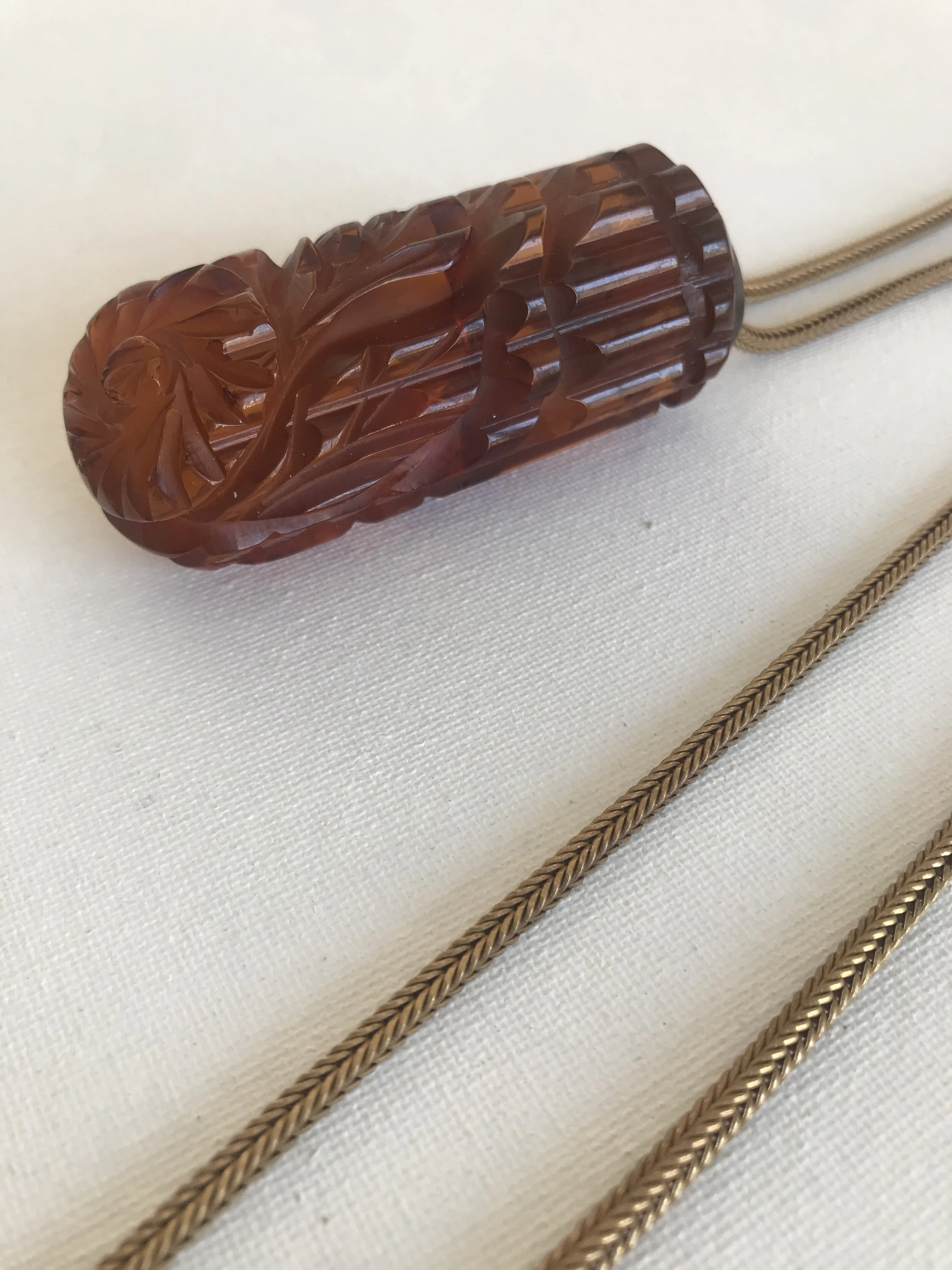 1930’s Cognac Carved Lucite Pendant