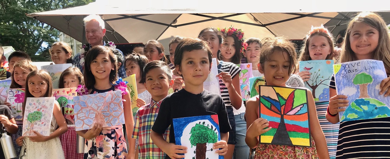 Mayor Caldwell and students celebrating the unveiling of “We Love Trees”