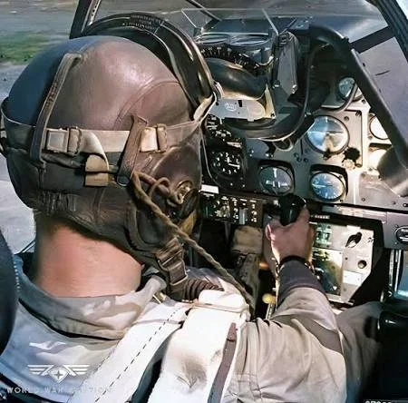 Picture of a Pilot sitting in a World War 2 figher cockpit