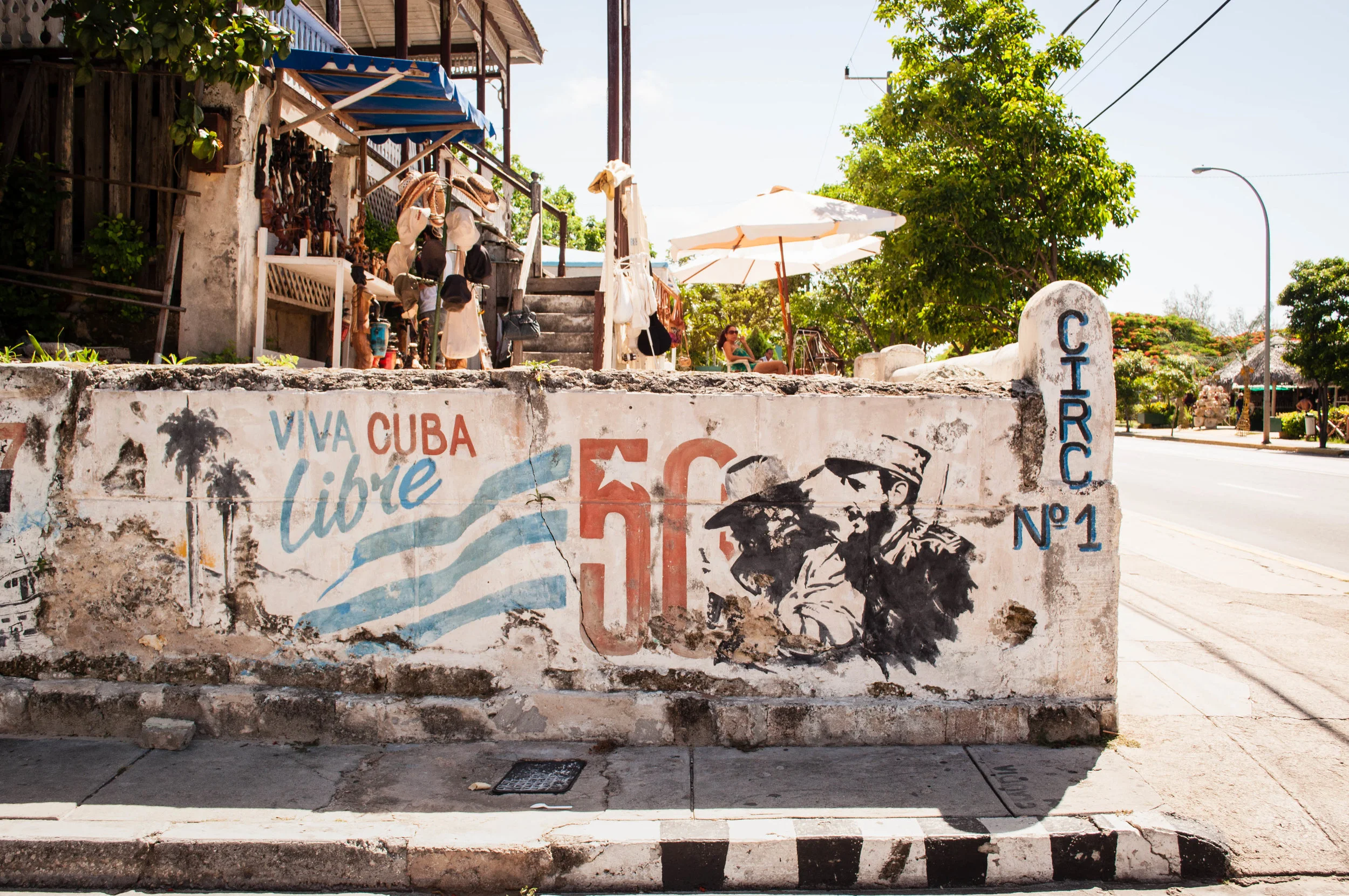 Decaying mural with el Che & Castro on a wall conveying a communist, revolution message on a house mural. Scene seeing during our day trip to La Havana