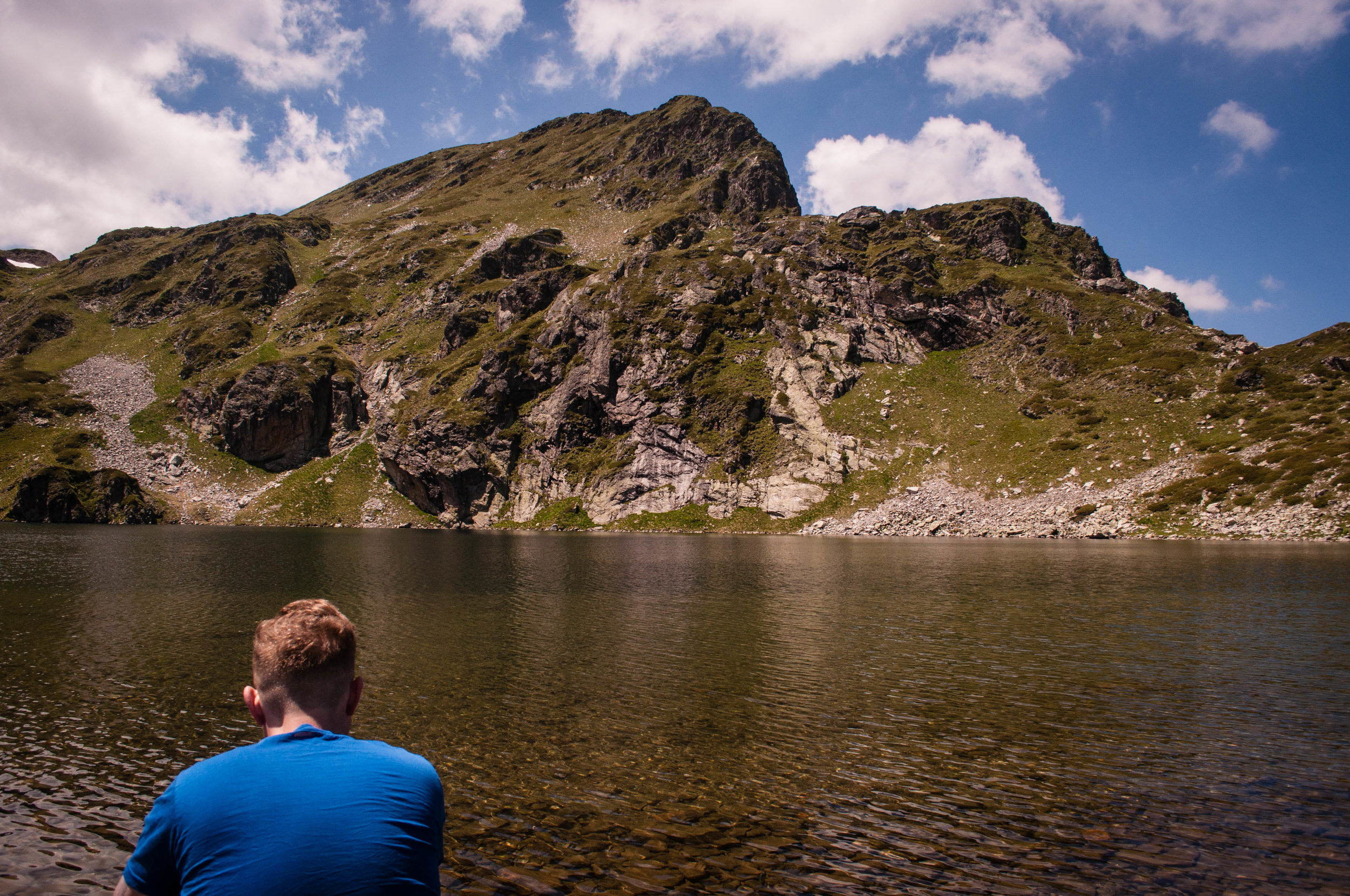 Men with blue shirt looking at one of the Seven Rila Lakes this was one of our stops in our Road trip in Bulgaria