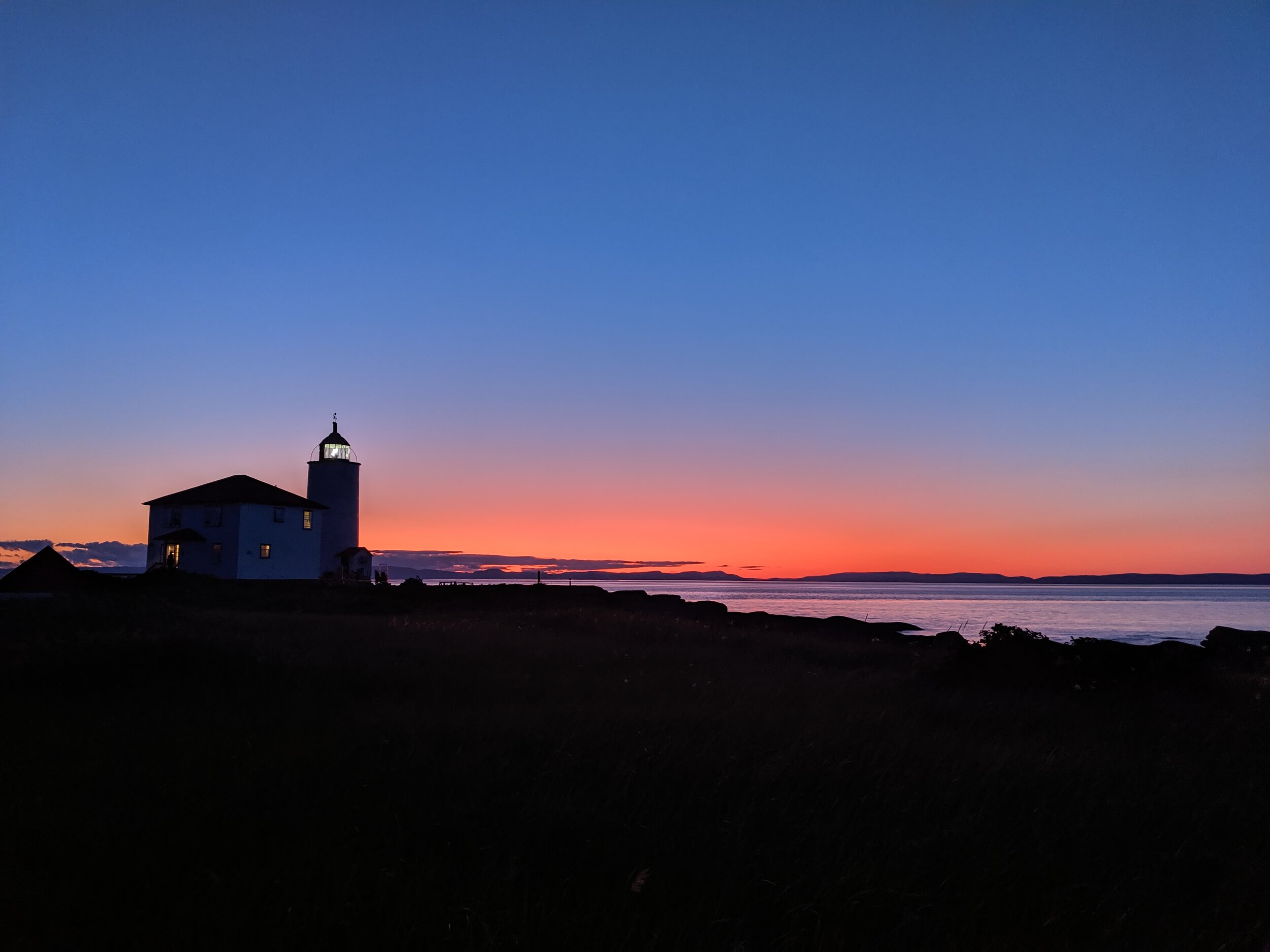 Sunset against Ile Verte lighthouse. Road trip in Gaspésie