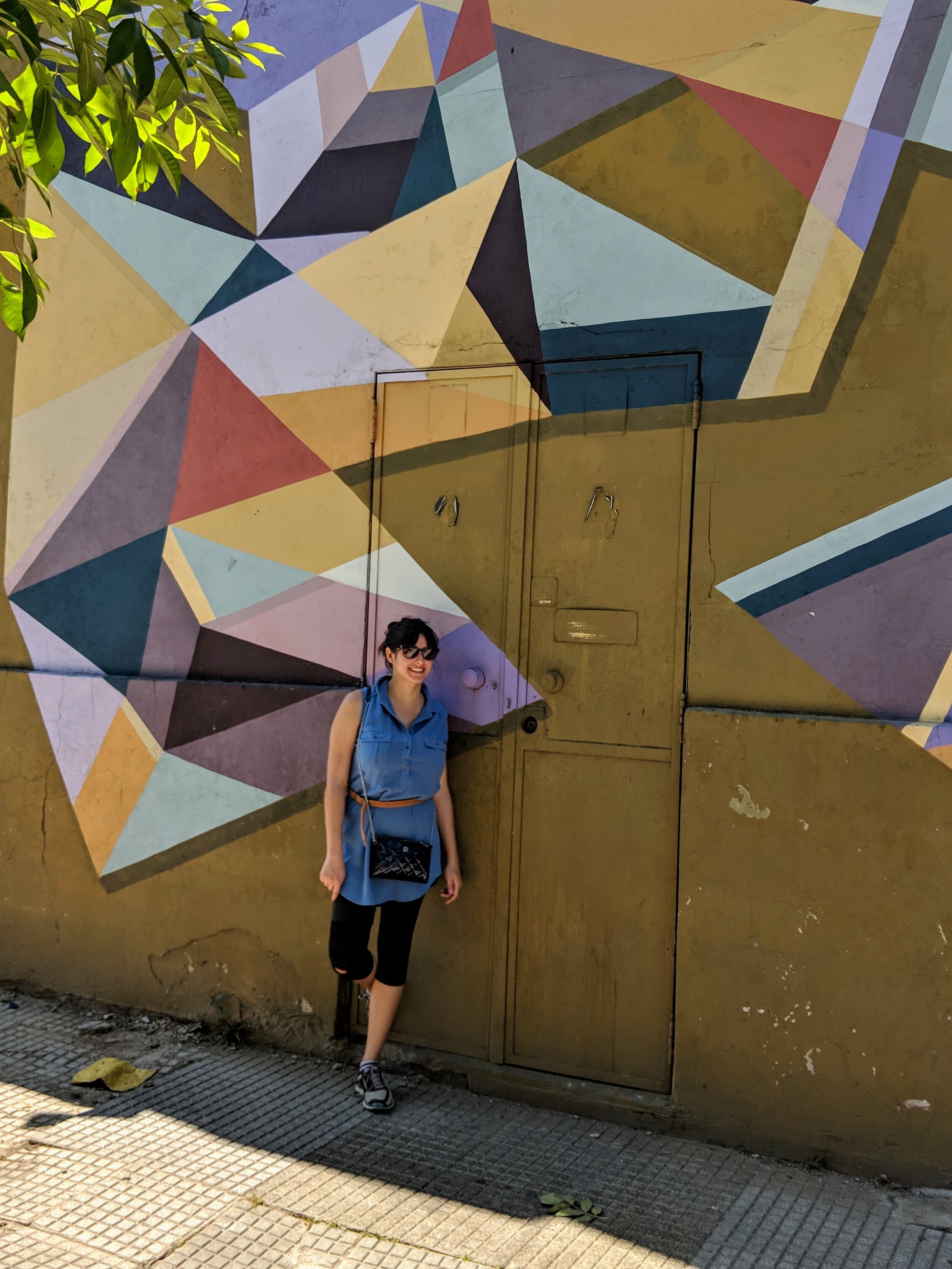 Woman against a colourful mural with geometric forms in Buenos Aires. How to spend 10 days in Argentina 