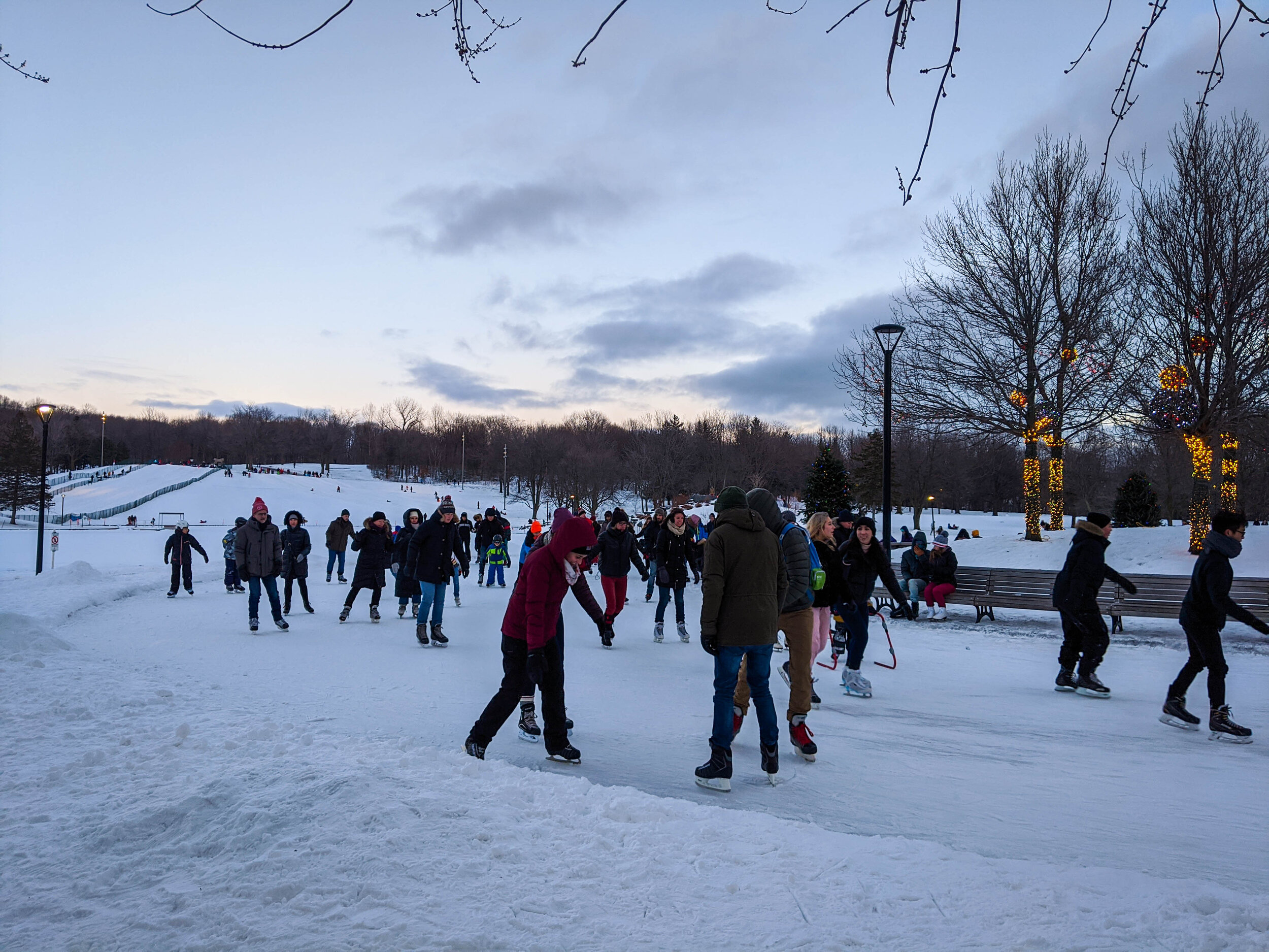 People ice skating at Lac aux Caster in Mont-Royal (Montreal)