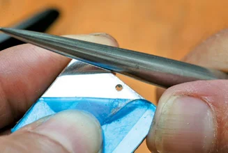 Burnish the silver edge upwards slightly to give and edge for enamel to adhere to