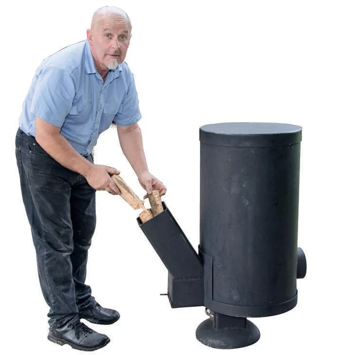 Stuart demonstrating how the Rocket Stove feeds.
