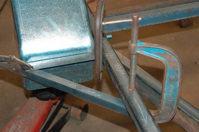 Attach mudguard angle mount under beam.