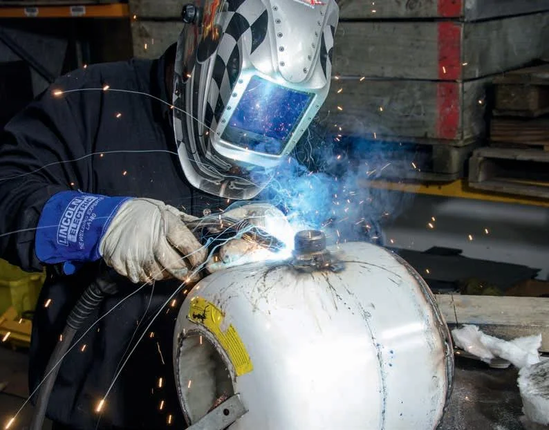 The pipe fitting welded to the bottle. The fitting was heavily galvanised which explains the sparks.