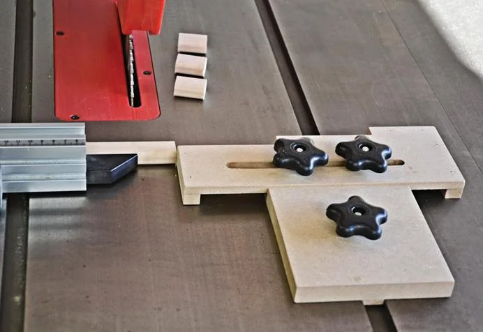 Jig slides in T slot and is secured by plastic knobs.
