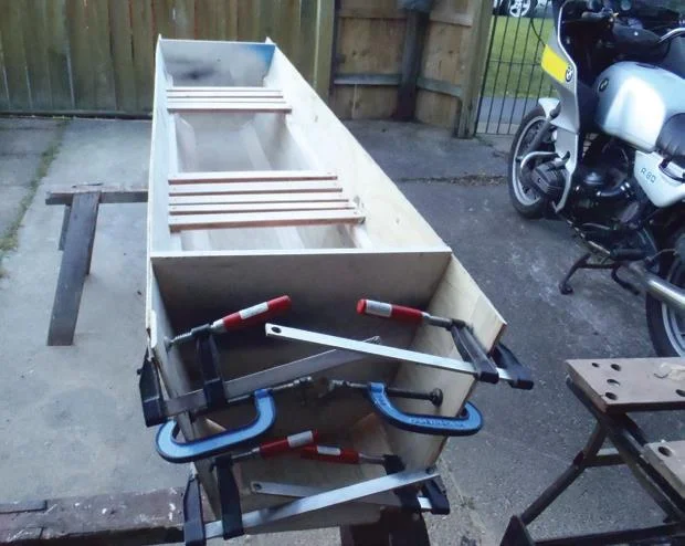 Doubler for joining is clamped while glue dries. Seat slats are glued and screwed, then dowelled, to long cleats. Temporary customwood frame is screwed in place at each end.