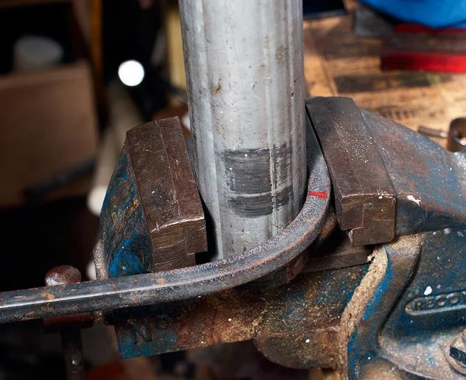 Bending the handle against the tube former. Note the mark at 190 mm.