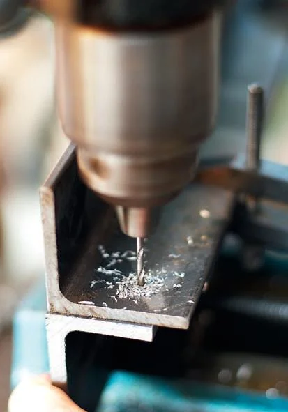 Drilling the pilot hole in the form bars.