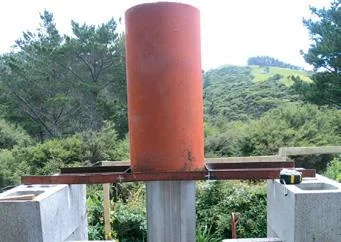 Welded angle-iron frame supports field tile around flue.