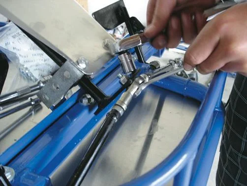 Attaching the steering arms.