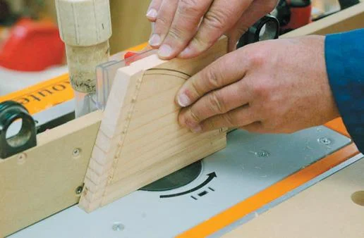 Routing the tenon to size in the seat support.