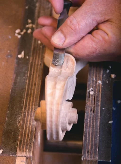 Use gouges to create flutes either side of the scroll block.
