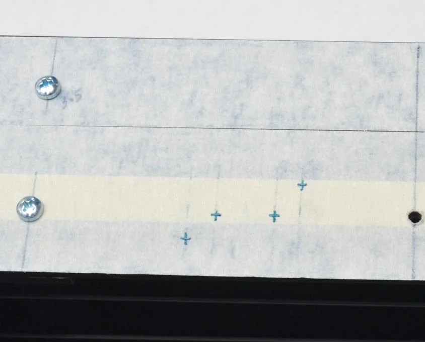 Holes marked for button board.