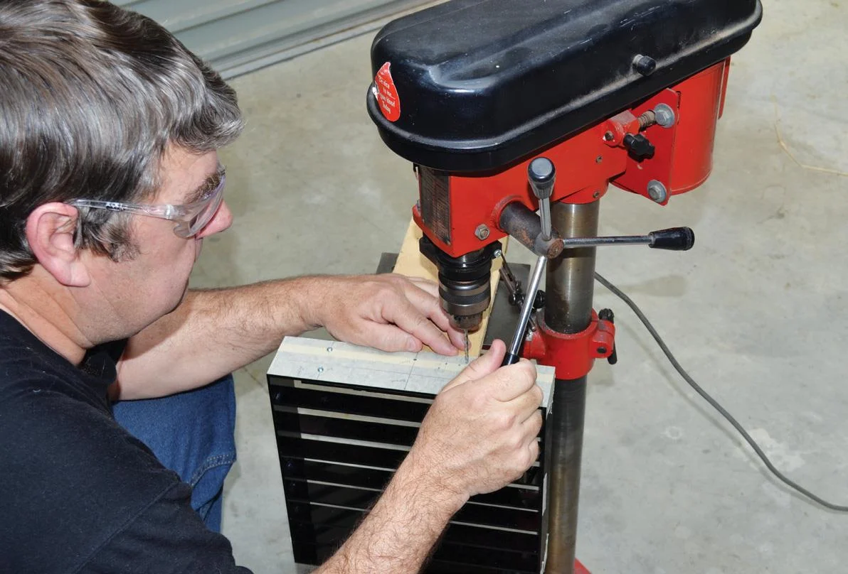 Drilling the enclosure base for button board.
