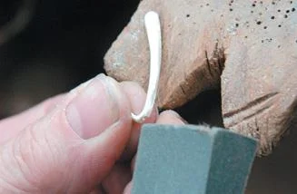 Soften with emery paper.
