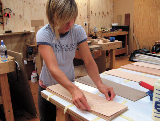 Placing the veneer: note the tape ready to hold the sandwich together.