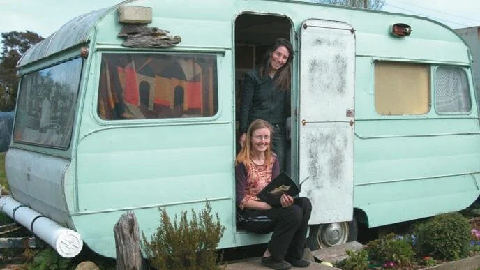 Lilach Paul (standing) and Fiona Mead... the caravan “shed.”