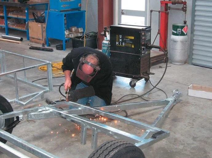 Welding the rubber blocks in place; keep a bucket of water handy so the rubber won’t be affected by the heat
