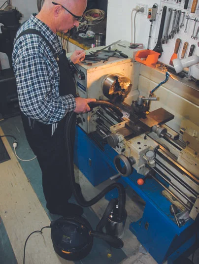 Vacuuming up the swarf.