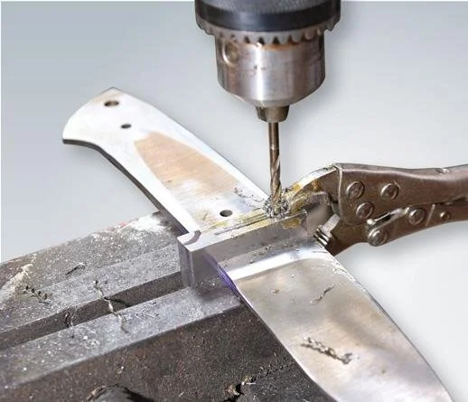 Drill hole through guard and blade