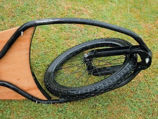 Front wheel pivots on swing arm