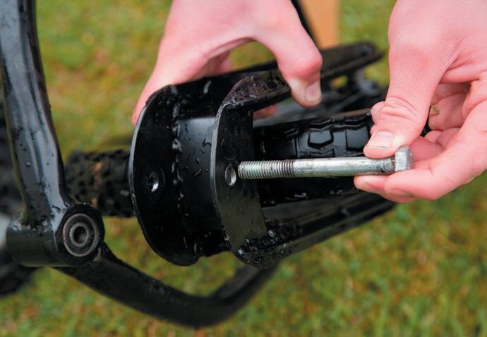 Swing arm attaches through bearing