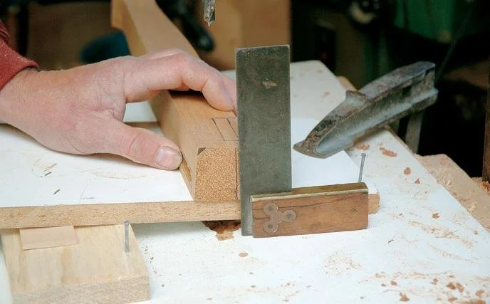 Checking the angle of the side rail mortises in the right front leg. The left leg will be reversed in the jig (ie. facing away)