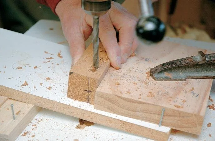 Drilling out the front leg mortise for the side rails