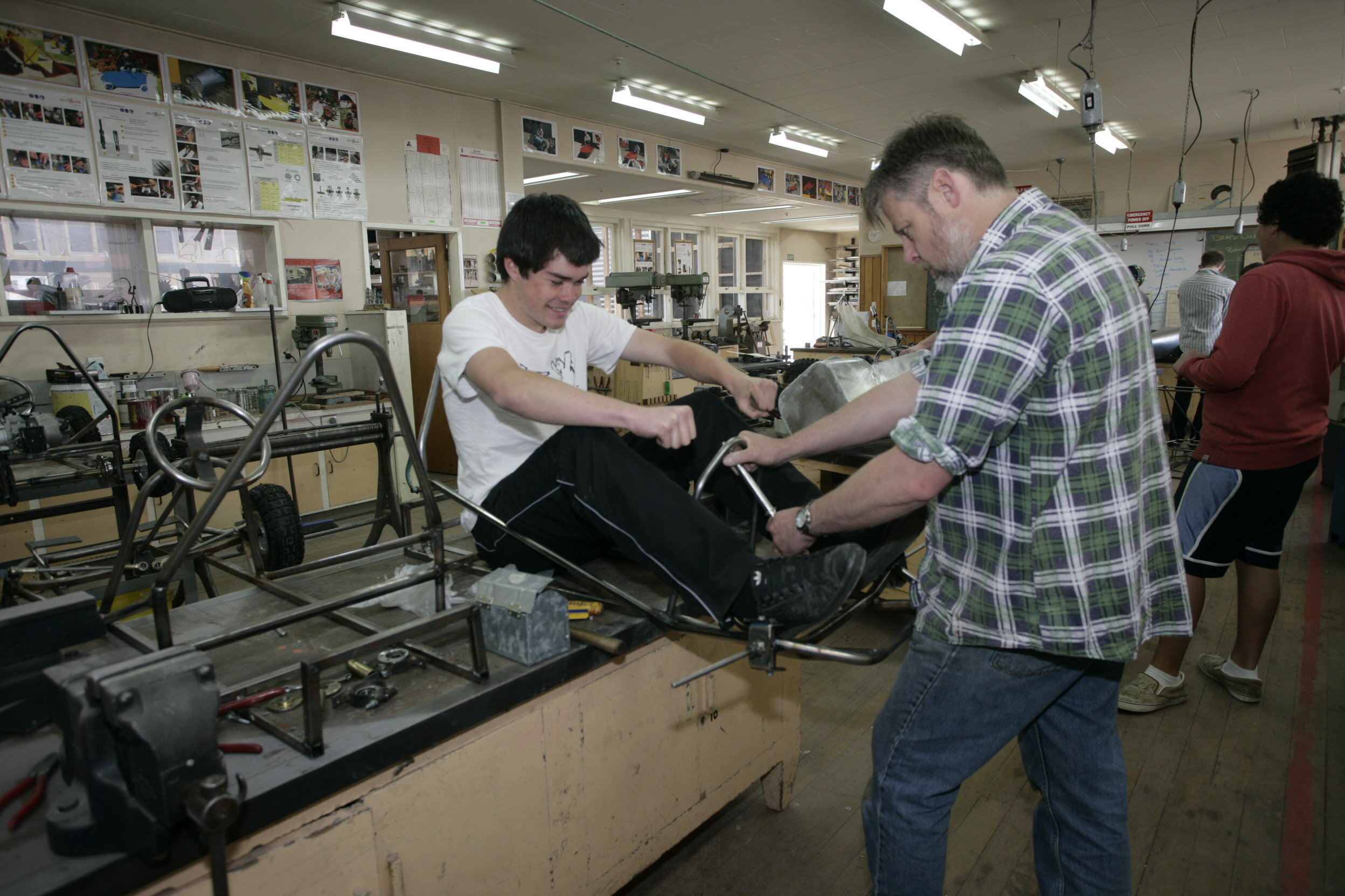 Teacher Patrick Neal assesses steering wheel position.