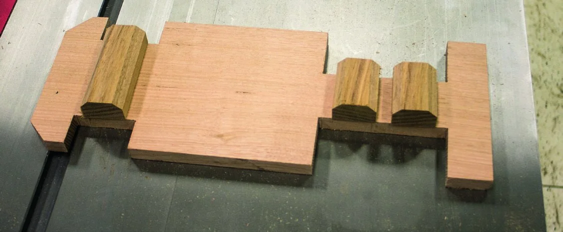 A rectangular block with wheel arches cut out. Chamfer front and back and nipping corners away defines bumpers.