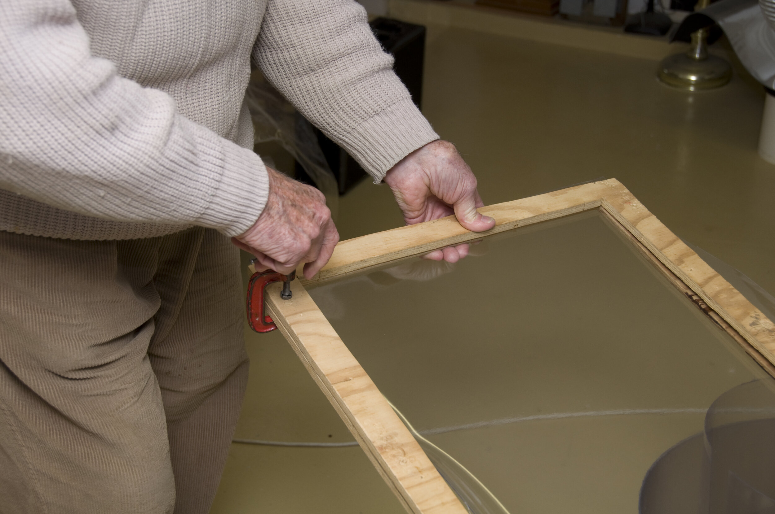 Clamps applied to frame which holds plastic sheet