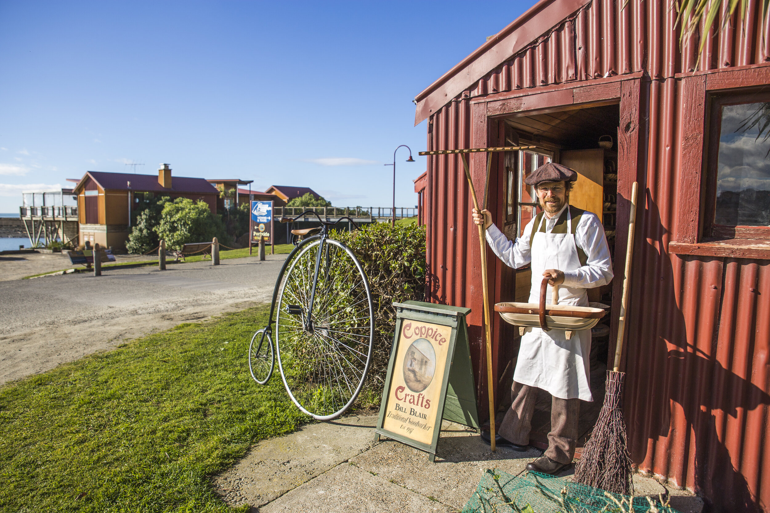 Traditional woodworker Bill Blair holding finished trug. He also enjoys wearing traditional clothes