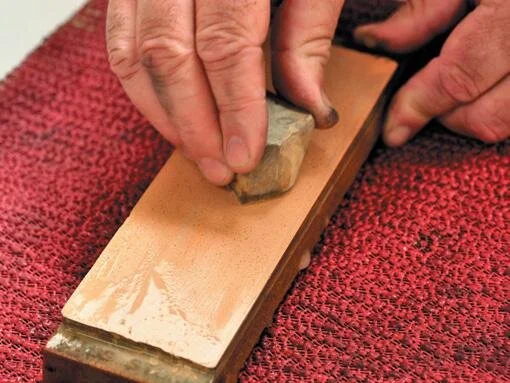 Using the Nagura stone to create paste on fine Japanese stone