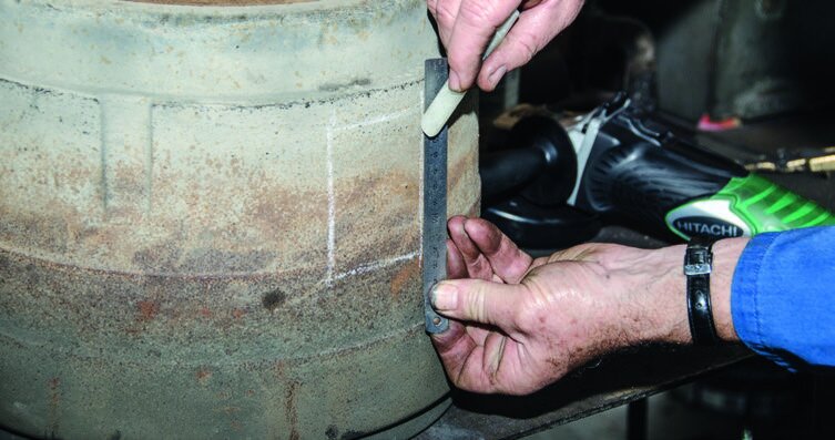 Cutting the chimney opening with an angle grinder. Take care not to get the blade jammed.  Below:   Bashing through the hole is the fastest way to remove the metal and then cleaning up the opening with a cold chisel.
