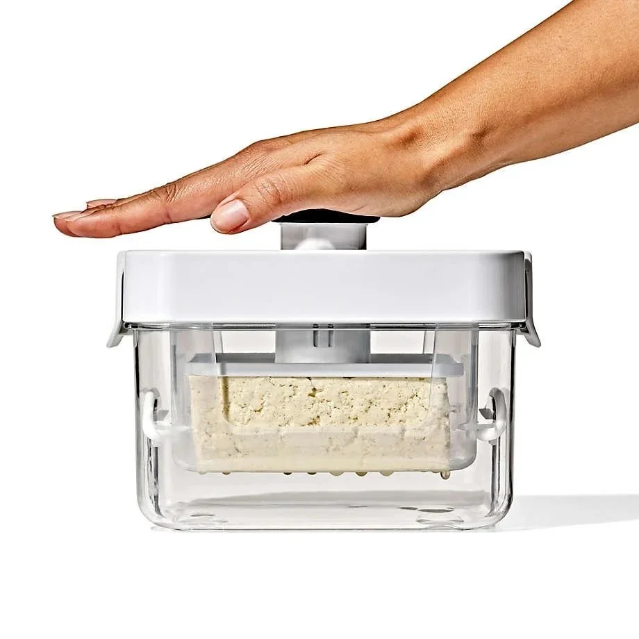  Born from the frustration of paper-towel mountains and wobbly canned-goods stacks, the tofu press was reimagined from the ground up — ditching the fussy metal springs for a single silicone band that doubles as a spring.   So why press your tofu? Sci