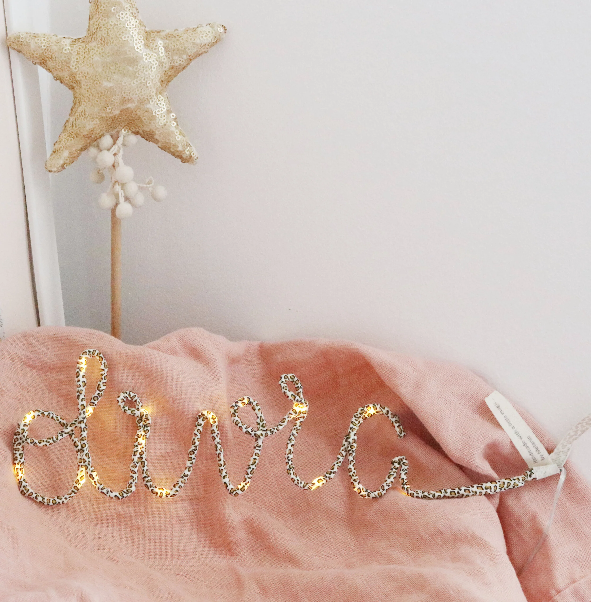 Personalised leopard print Olivia name light styled on pink bedding