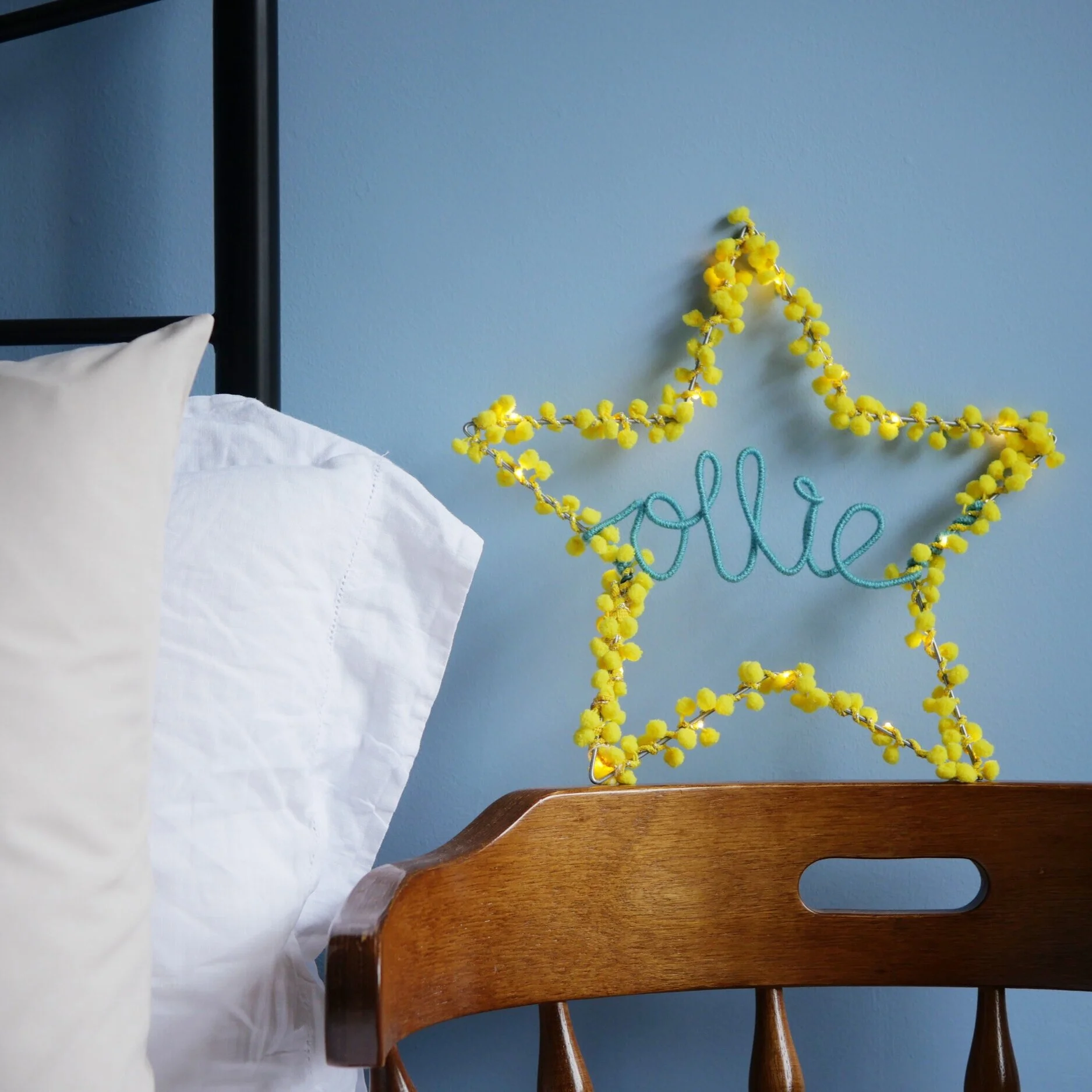 Yellow personalised star light with custom name displayed in a bedroom