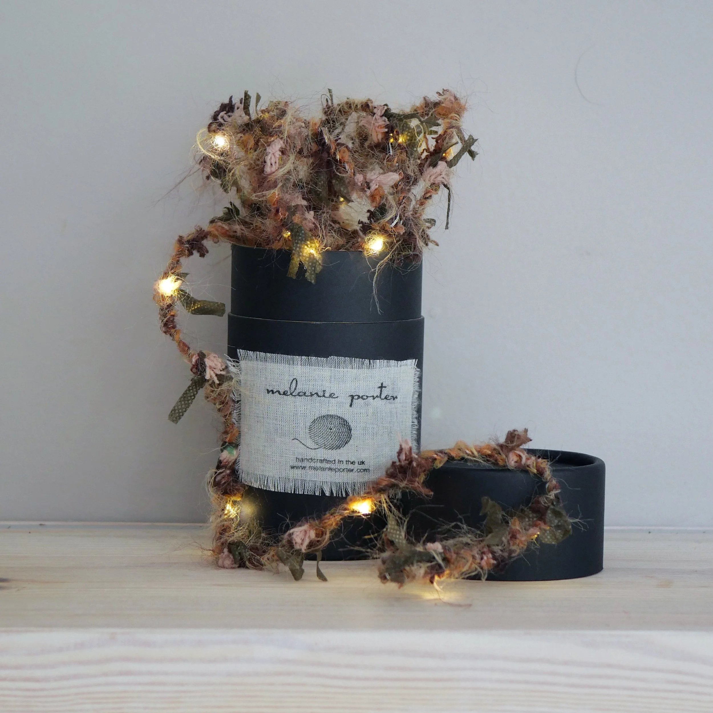 Autumn Hedgerow Fairy Lights displayed around a Melanie Porter gift box