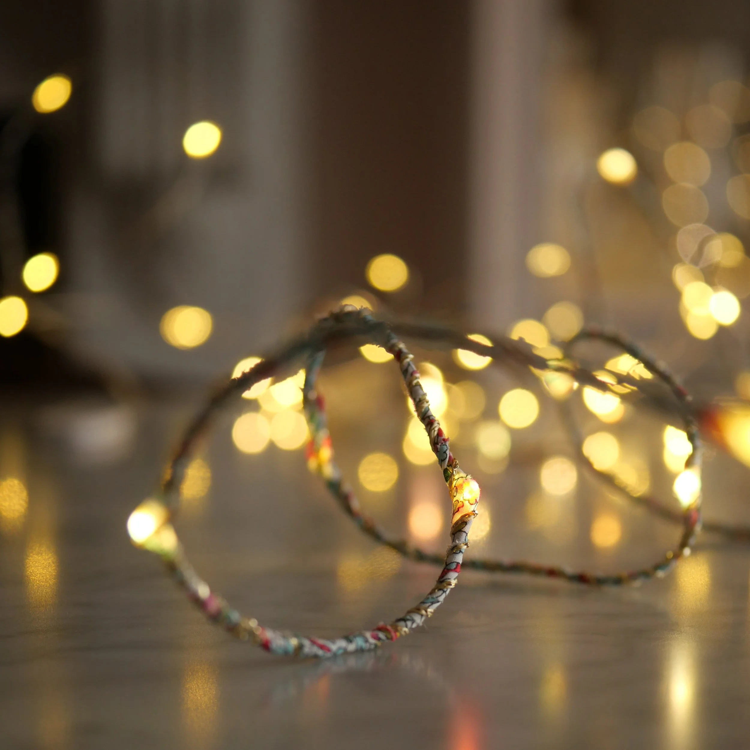 Liberty print fairy lights glowing warmly in a dark interior