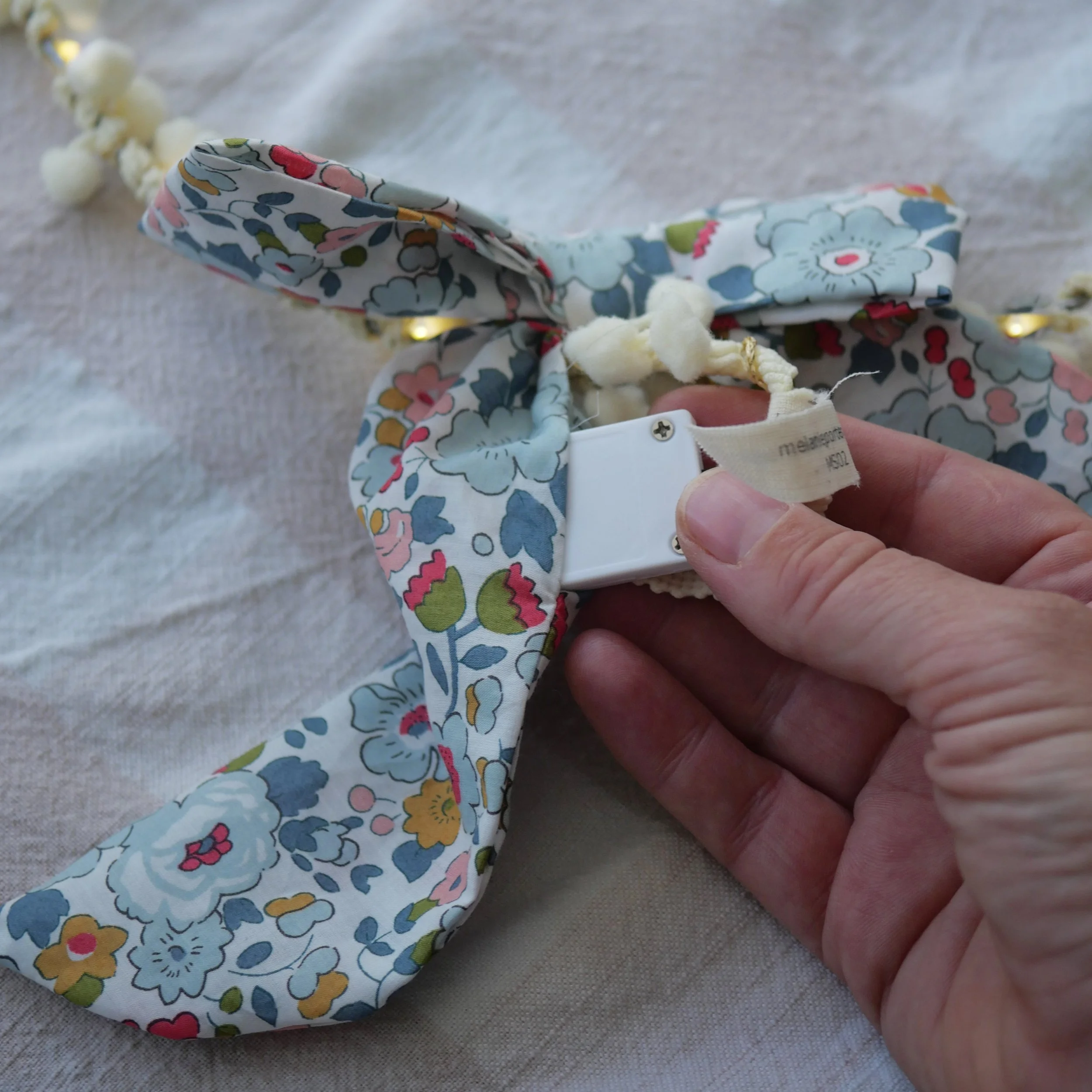 Liberty floral bow showing the hidden fairy light battery pack inside