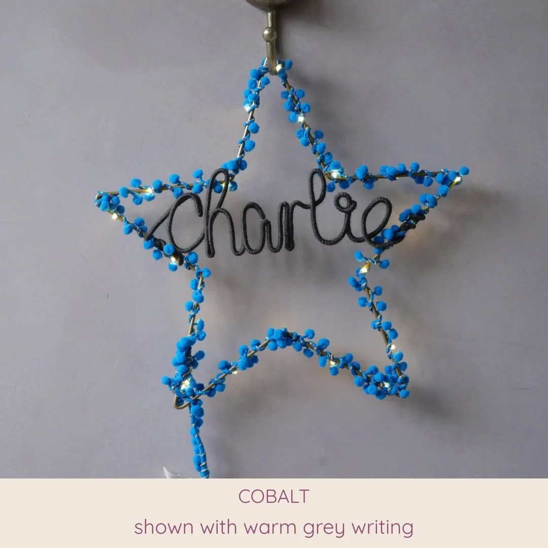 Cobalt blue personalised star light with Charlotte name in warm grey