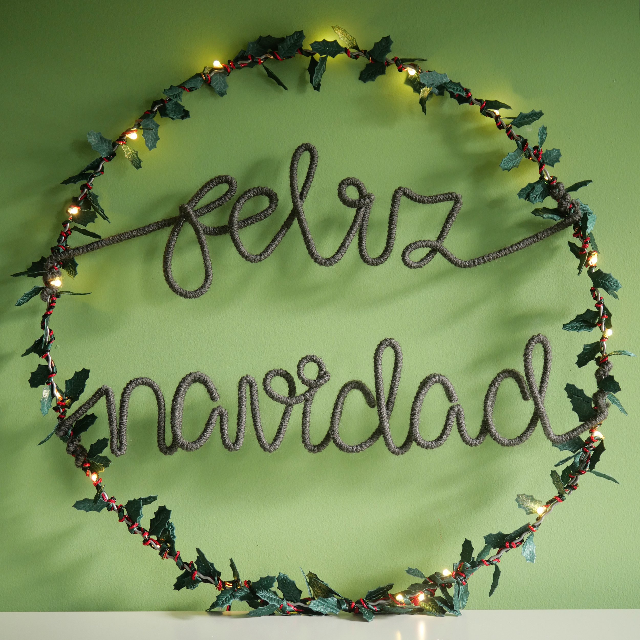 Feliz Navidad wreath with warm grey lettering and warm white lights