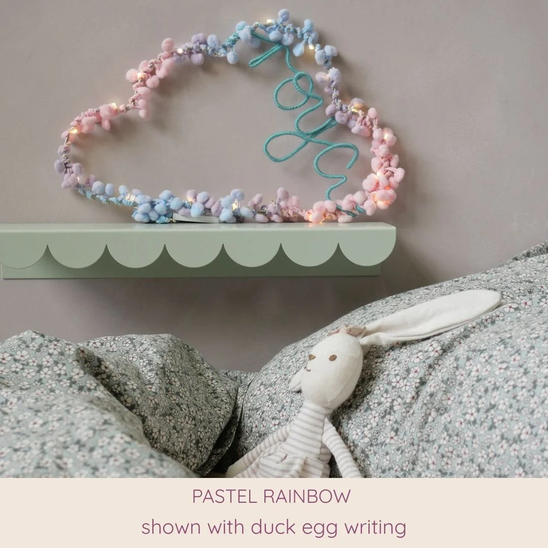Pastel rainbow personalised cloud light with duck egg custom name styled above a child's bed