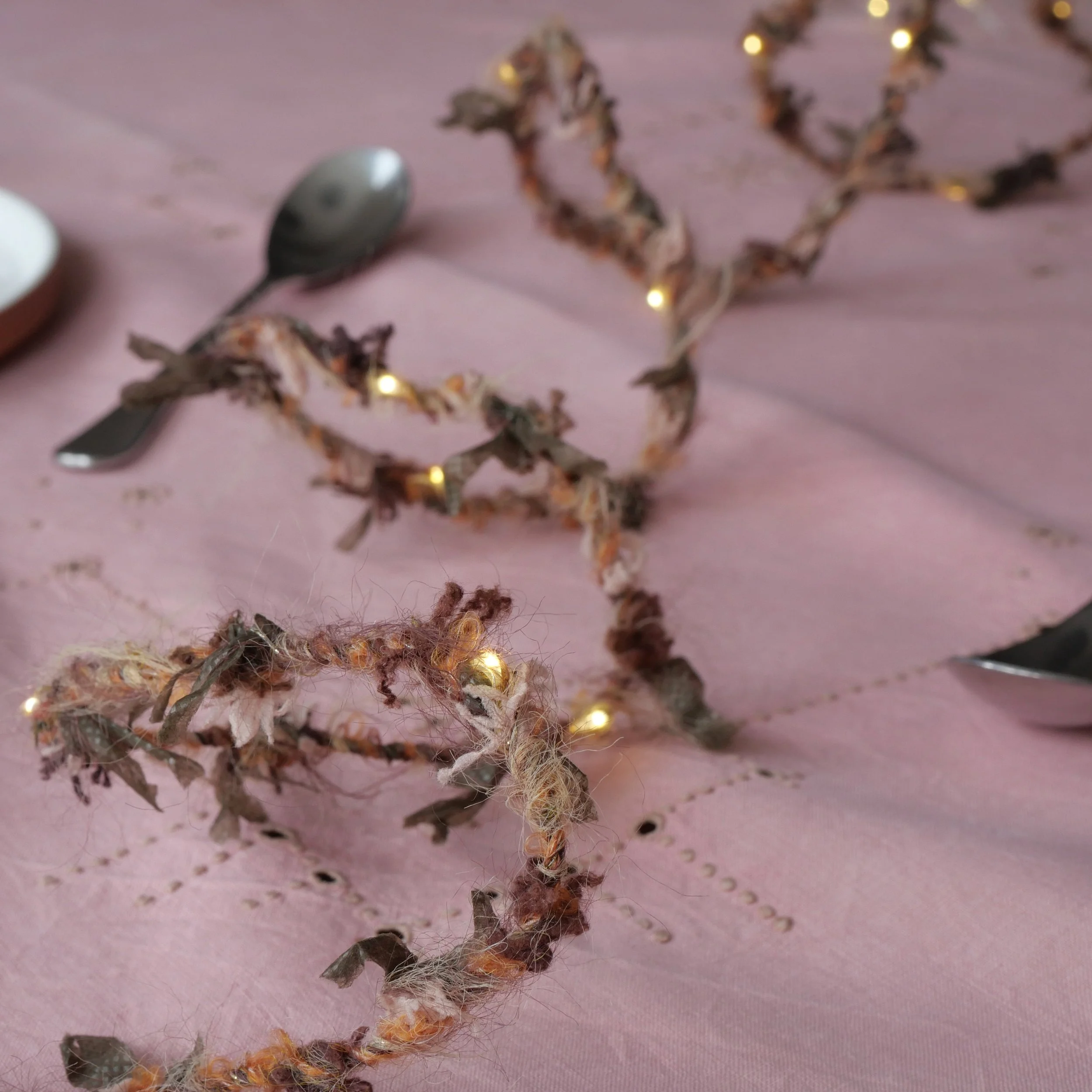 Autumn Hedgerow Fairy Lights styled across a pink table with warm white LEDs