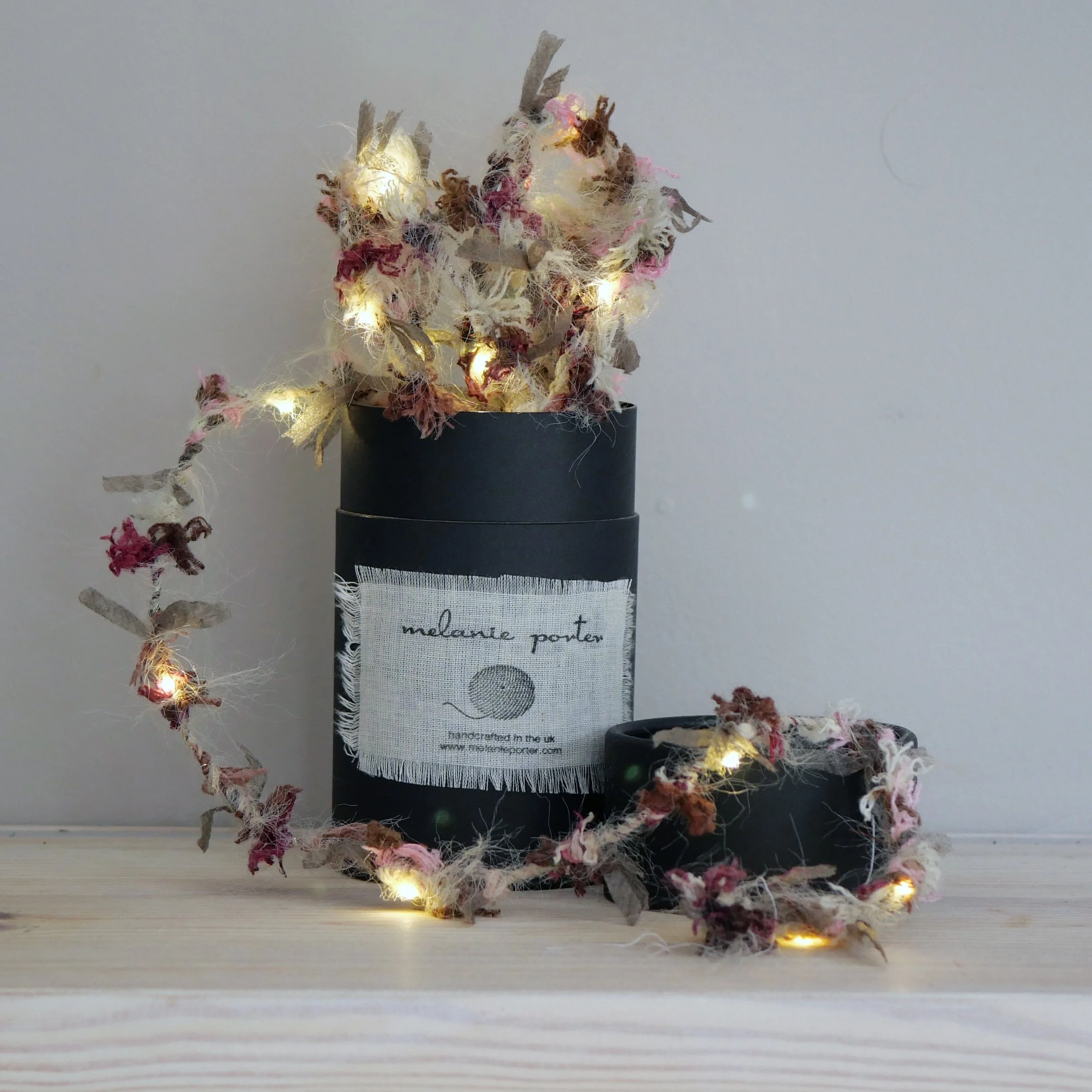 Berry Hedgerow Fairy Lights displayed around a Melanie Porter gift box