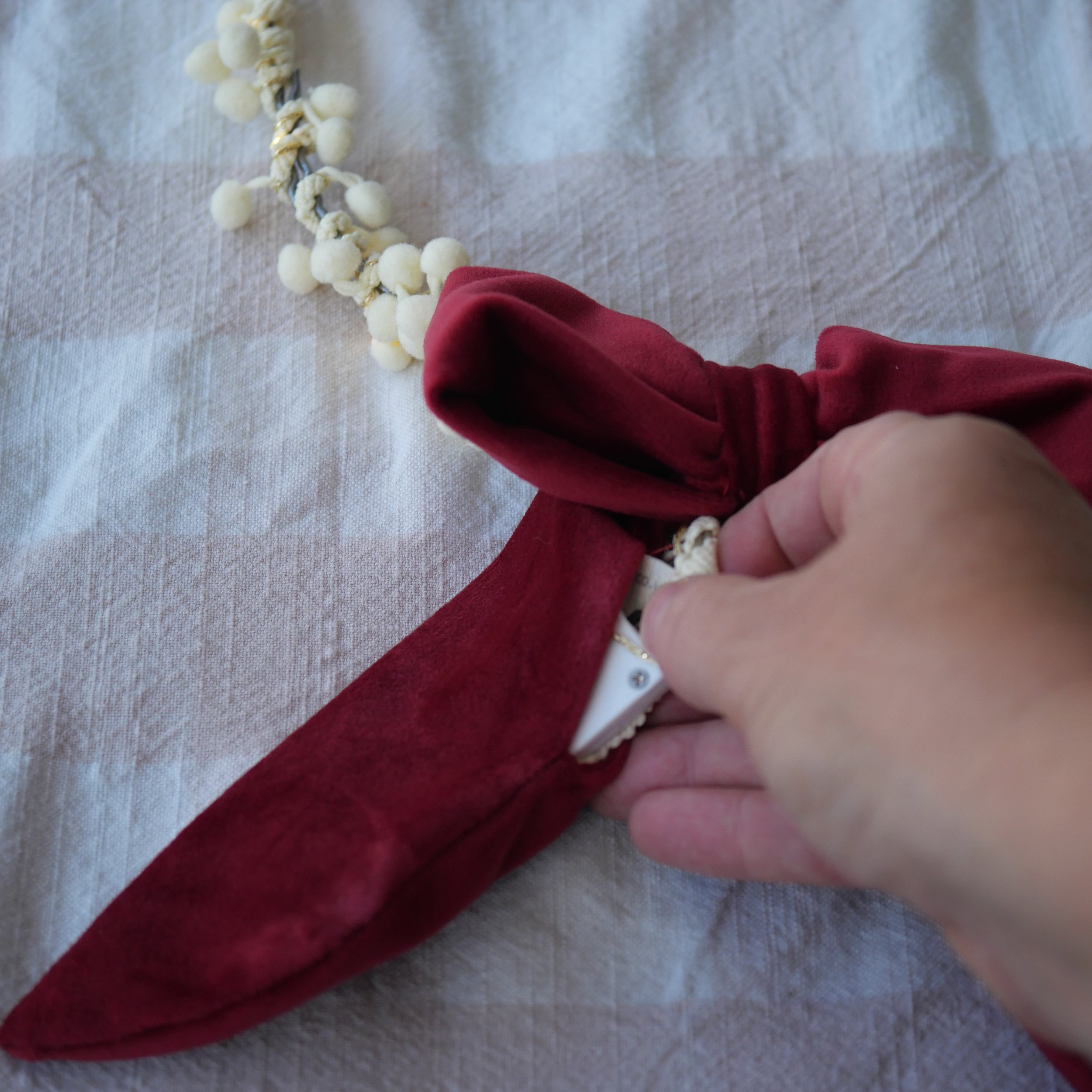 Red velvet bow showing the fairy light battery pack hidden inside